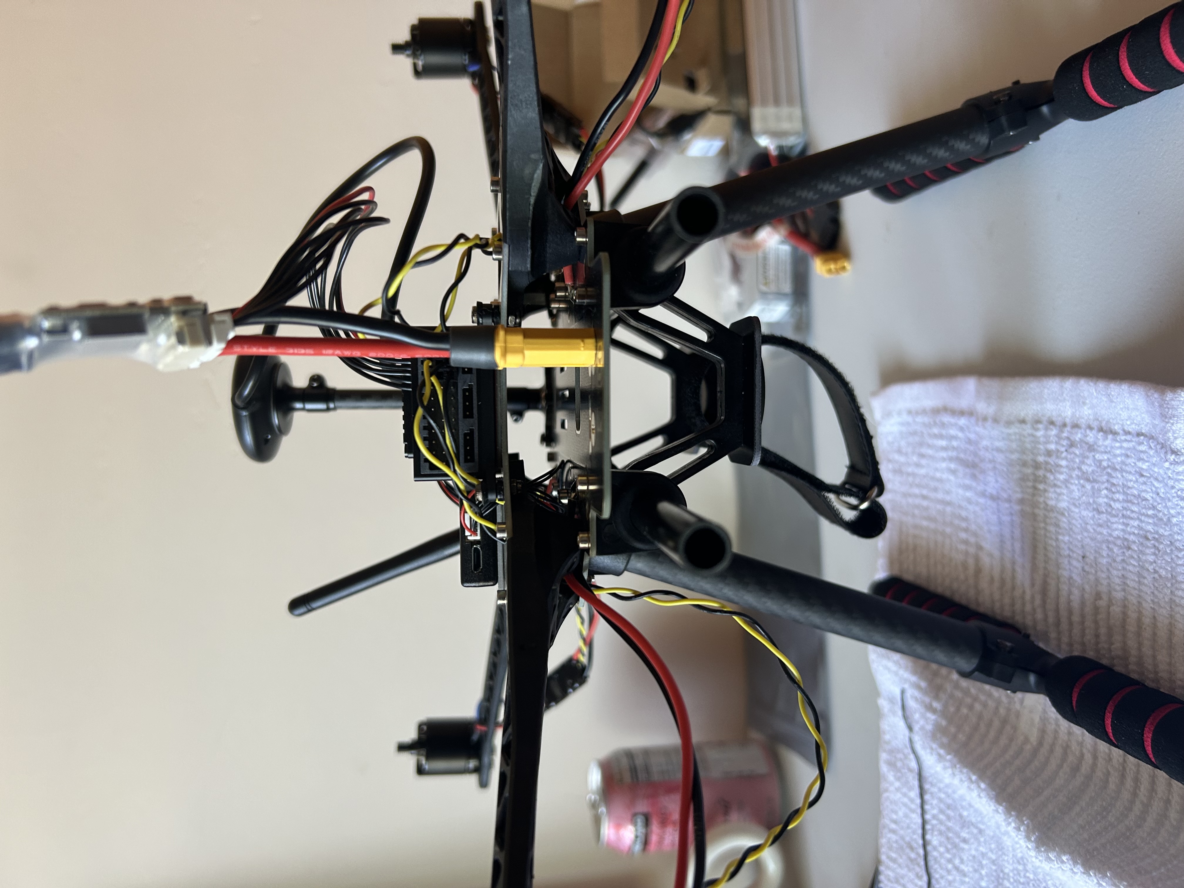 Side profile of the Holybro S500 showing landing gear, GPS mast, power connector, and partially routed wiring.