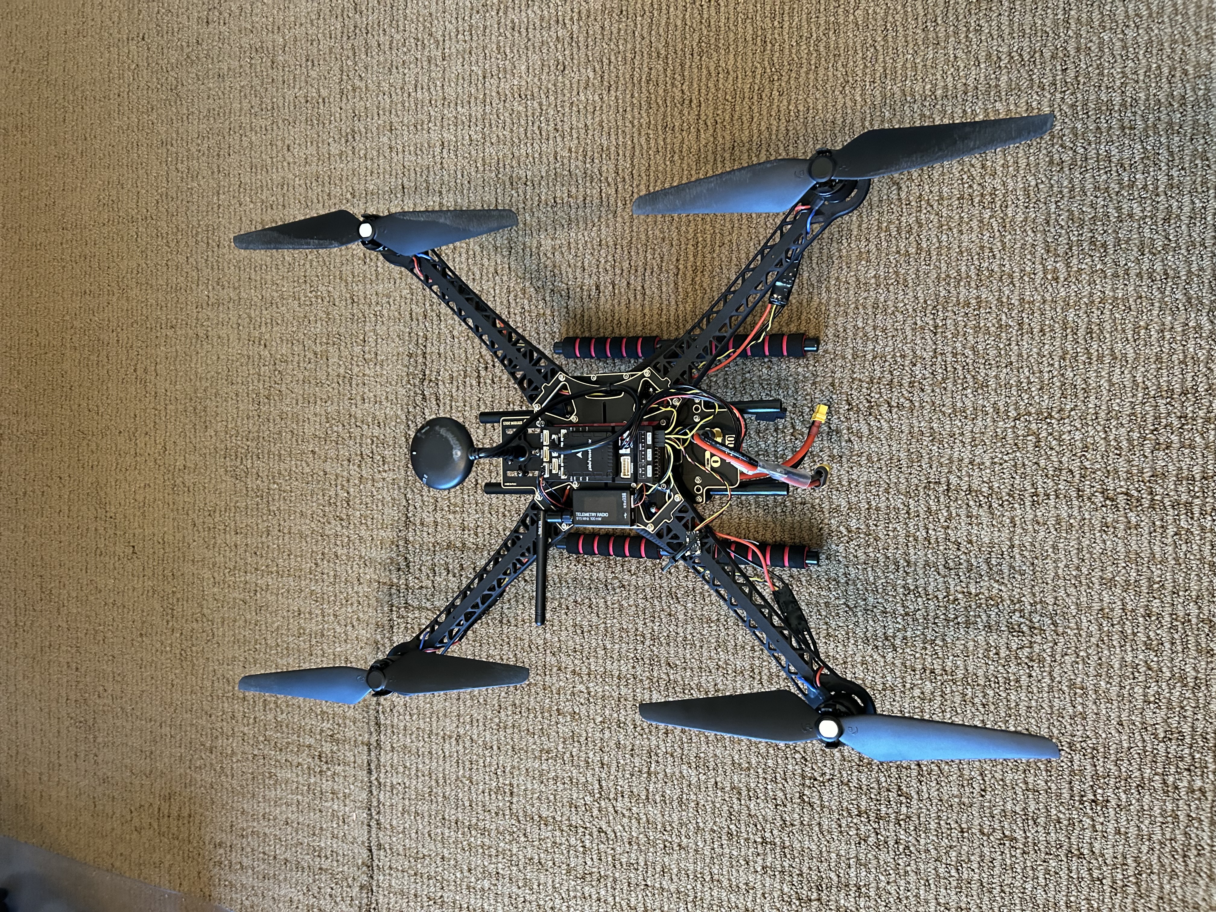 Final assembled Holybro S500 shown from above with props on and the full avionics stack installed.